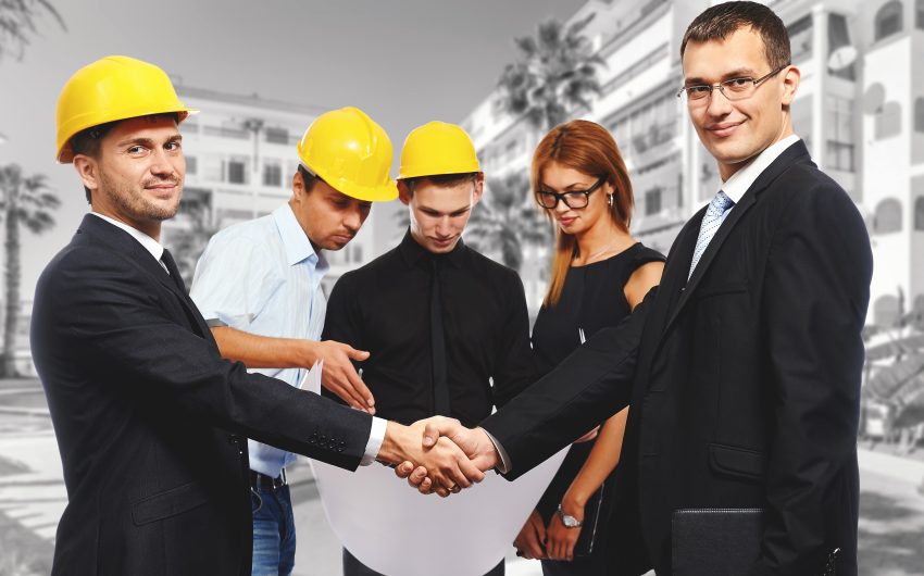 Business people shaking hands, finishing up a meeting. Construction theme